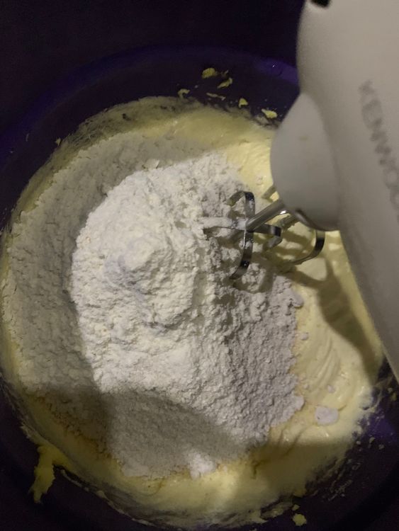 Step 1.1: Add half of the dry ingredients into the creamed butter and egg mixture