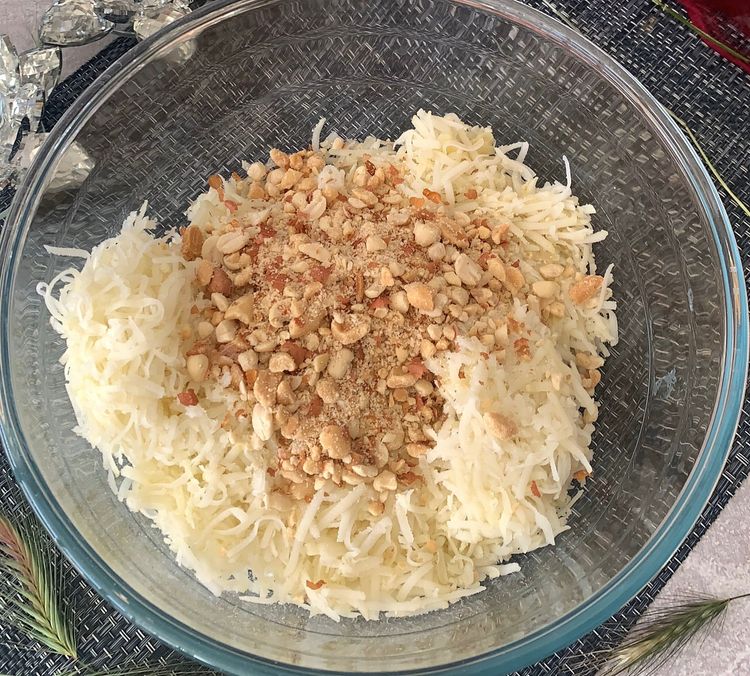 Step 1.1: In a mixing bowl, combine the sabudana powder, grated boiled potatoes, coarsely ground roasted peanuts, green chillies, red chilli powder, cumin powder, coriander powder, rock salt and chopped coriander leaves