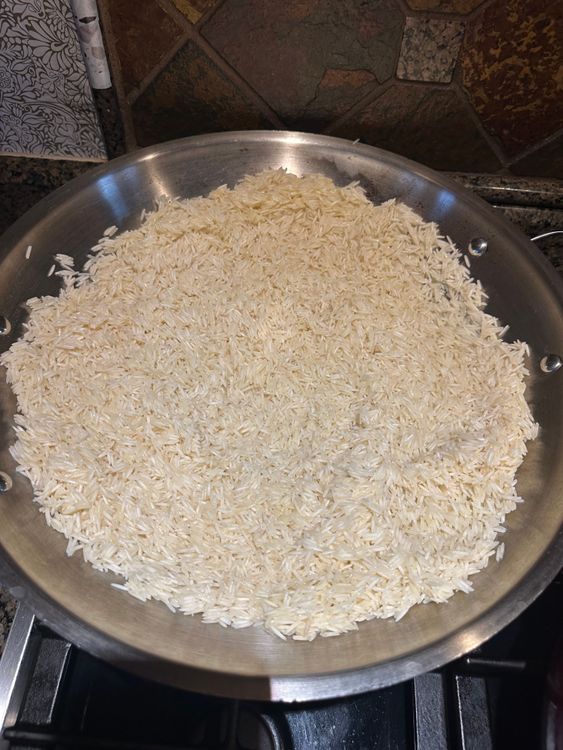 Step 3.1: Add the drained rice and toast it for 1-2 minutes, stirring often to prevent burning