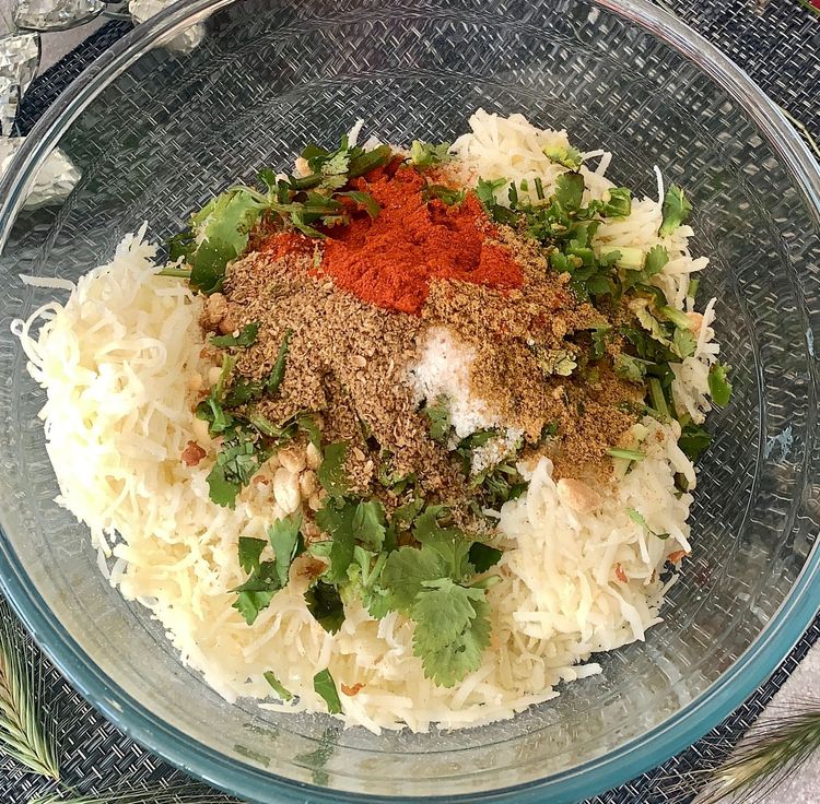 Step 1.2: In a mixing bowl, combine the sabudana powder, grated boiled potatoes, coarsely ground roasted peanuts, green chillies, red chilli powder, cumin powder, coriander powder, rock salt and chopped coriander leaves