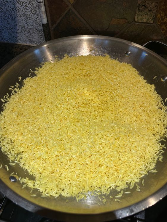 Step 3.1: Once toasted, add turmeric powder and saffron, mixing well for an even color and flavor
