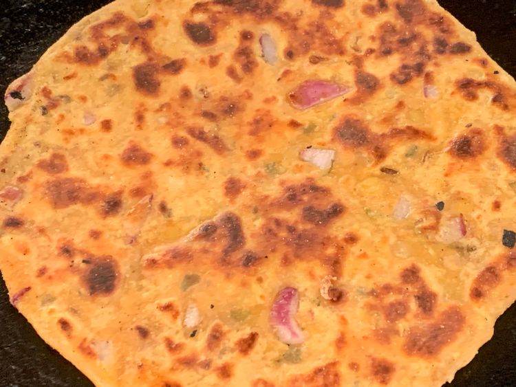 Step 1.2: Brush the paratha with some oil, flip it again, and press gently with a flat spoon until lightly golden