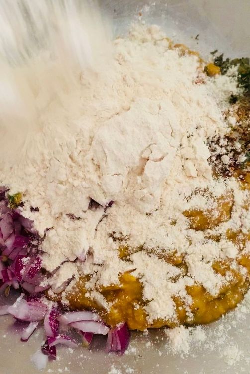Step 1.2: In a large mixing bowl, combine the cooked lentils (daal), wheat flour, chopped onions, green chillies, salt, red chilli powder, coriander powder, dry pomegranate seed (anardana), dry fenugreek leaves and garam masala