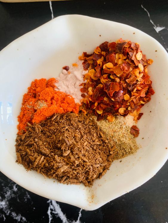Step 1.1: Stir in sugar, asafoetida, Kashmiri red chilli powder, black salt, roasted cumin powder, chilli flakes, and chaat masala until the sugar dissolves