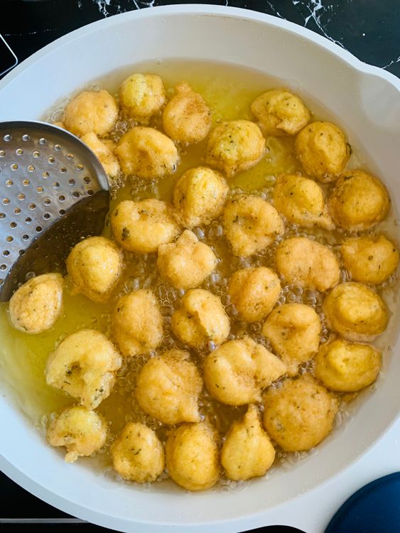 Step 3.1: Take small portions of batter with your fingers or a spoon and gently drop them into the hot oil