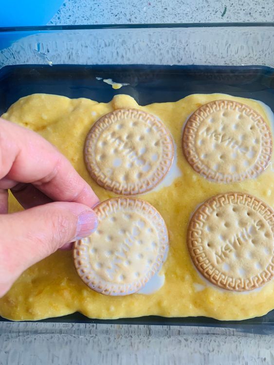 Step 3.1: Repeat the process, alternating layers of biscuits and mango cream