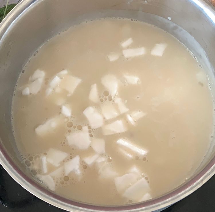 Step 1.2: Add the translucent sabudana and the sliced coconut to the simmering milk