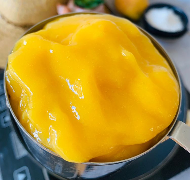 Step 1.1: Add the mango puree, and cardamom powder and stir them for a minute