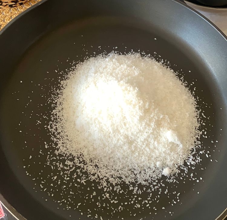 Step 1.1: Dry roast the desiccated coconut in a non-stick pan over low-medium heat, stirring continuously until slightly golden