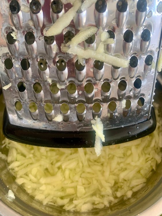 Step 1.1: Grate them, discarding the seeds, into a bowl of water mixed with 1 tsp of salt to prevent discolouration
