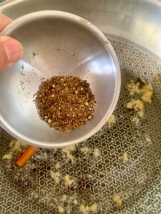 Step 2.1: Stir in the coarsely ground peppercorns and cumin, and sauté for a few seconds