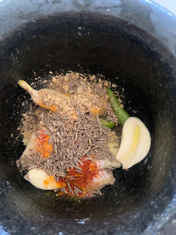 Step 1.1: Grind ginger, garlic, green chillies, coriander, and cumin seeds into a coarse paste