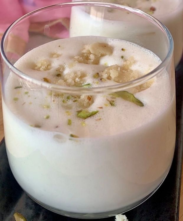 Step 1.1: Pour the lassi into serving glasses and garnish with sliced or chopped nuts and some crumbled burfi