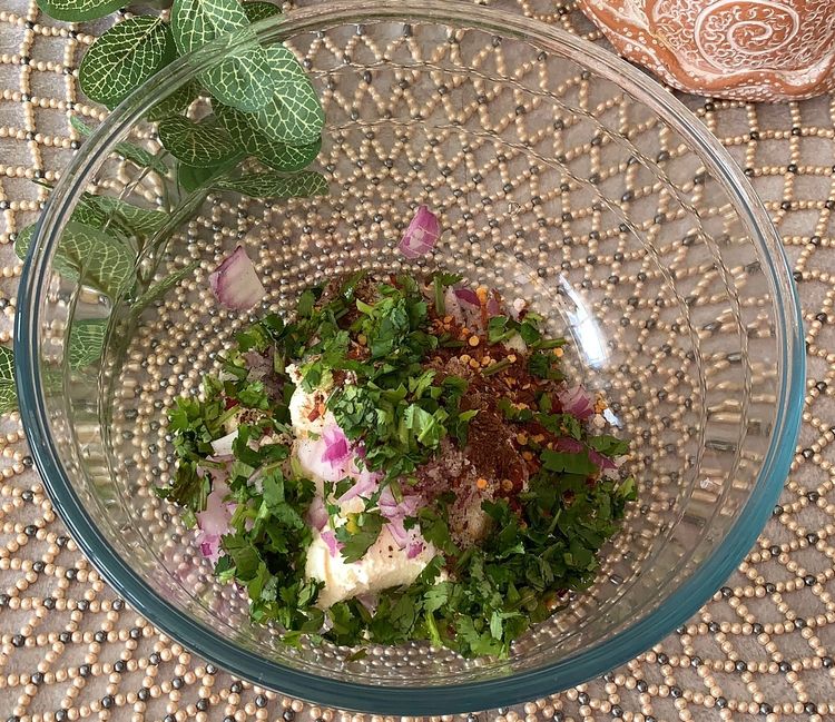 Step 1.1: In a mixing bowl, add hung curd, onion, green chillies, red chilli flakes, roasted cumin powder, black salt, salt and coriander leaves