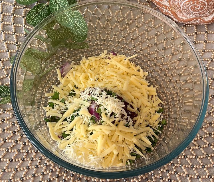 Step 1.1: Add grated paneer and cheese (if using), along with roasted gram flour