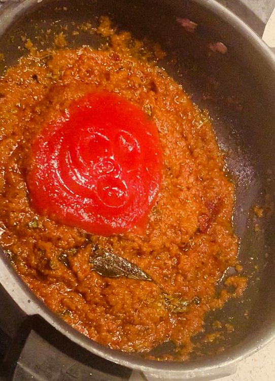 Step 2.1: Add tomato puree, salt and sugar to the pan and stir to combine