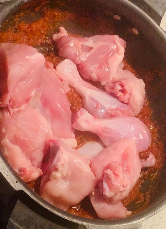 Step 2.1: Add the chicken pieces and mix well to coat them with the masala or gravy