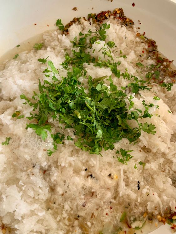 Step 1.1: Add the grated radish and fresh coriander