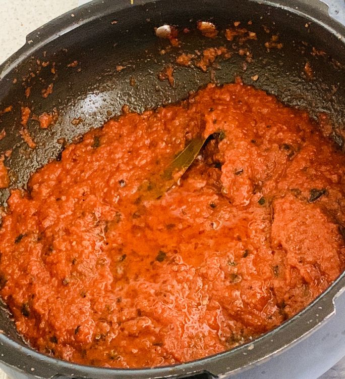Step 2.2: Add tomato puree, dry fenugreek leaves, turmeric, salt, and coriander powder to the wok and stir to combine