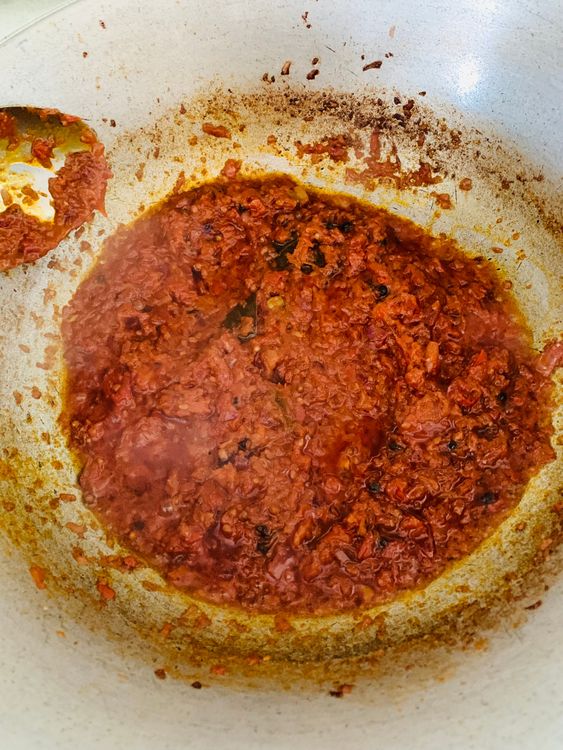Step 2.1: Add Kashmiri red chilli powder and cook until the oil separates from the masala