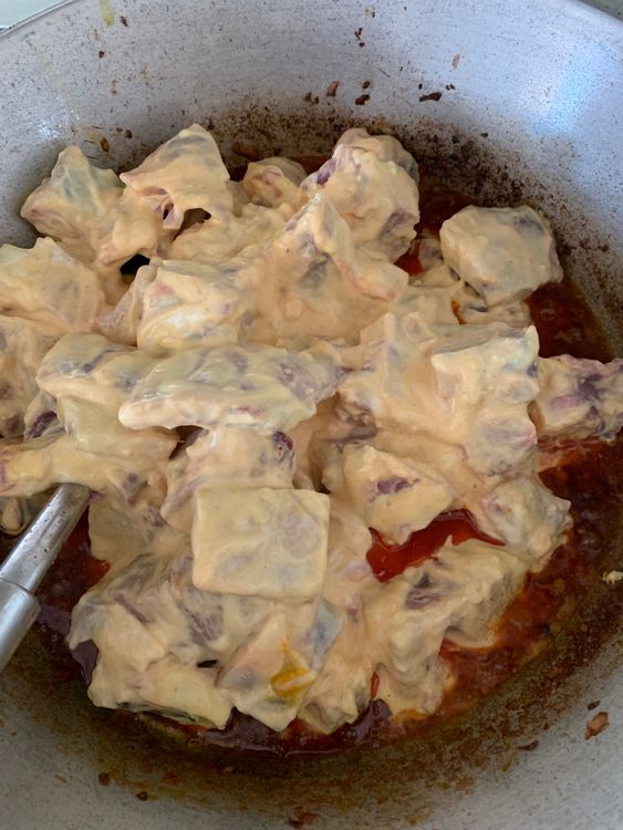 Step 3.1: Add the marinated mutton (reserve any excess marinade) to the pot