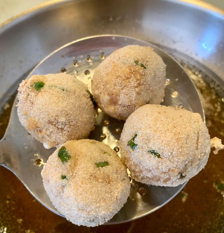 Step 1.2: Carefully place the coated chicken balls in the hot oil and fry them until they turn slightly golden