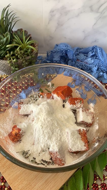 Step 1.1: Next, add rice flour and cornflour to the bowl, and once again toss the paneer cubes to coat them evenly