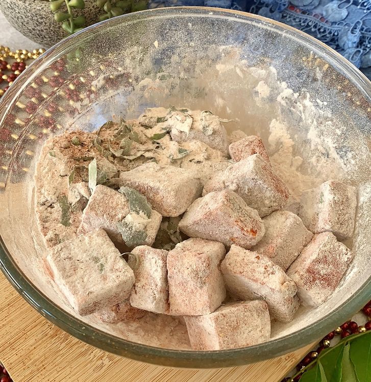 Step 1.2: Next, add rice flour and cornflour to the bowl, and once again toss the paneer cubes to coat them evenly