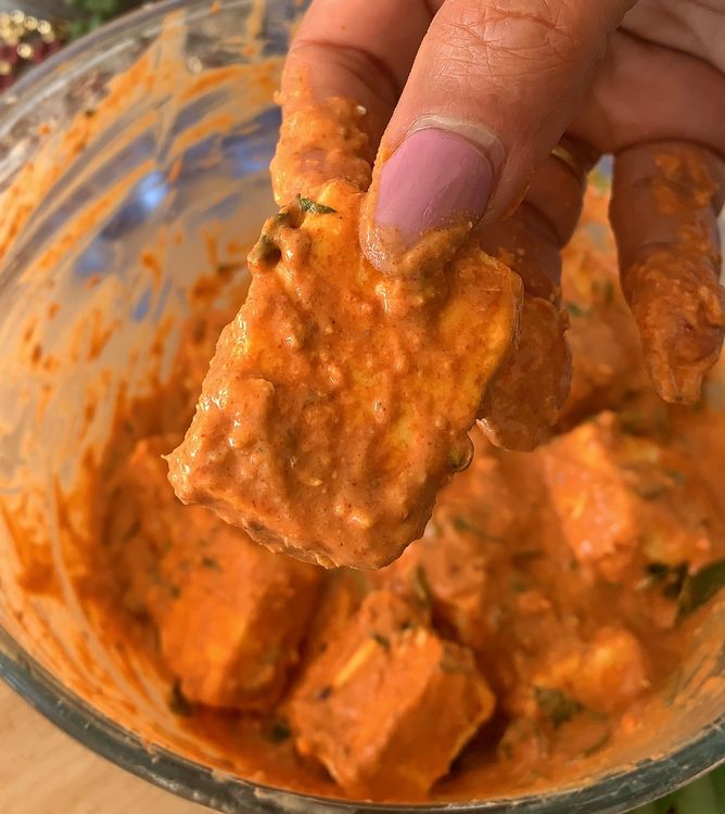 Step 1.2: Pour this curd mixture into the bowl of paneer, mixing well to coat the paneer cubes evenly