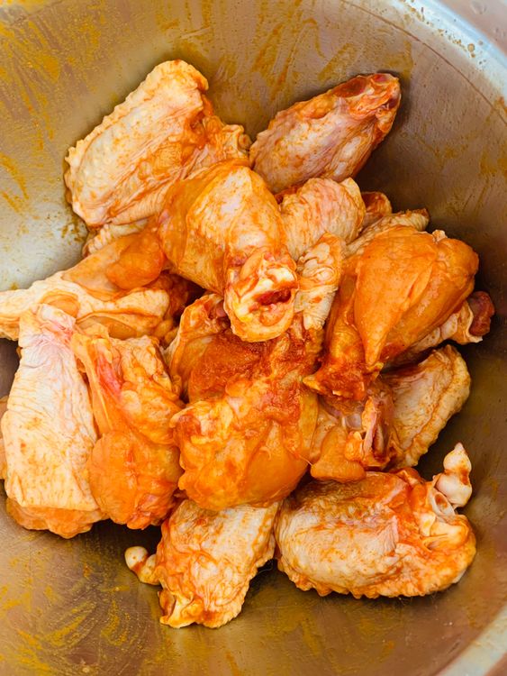 Step 1.1: In a large bowl, combine the chicken wings with lemon juice, Kashmiri red chilli powder, and salt