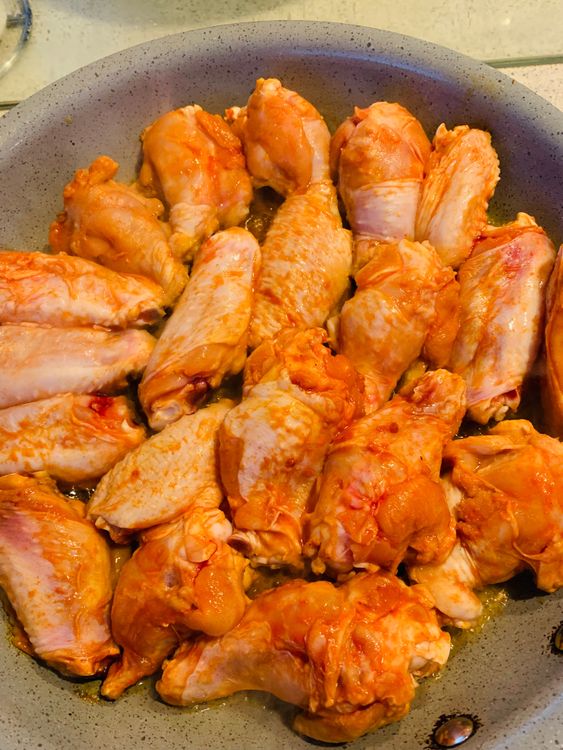Step 3.1: Add the marinated chicken wings and sear them until they are golden brown on all sides
