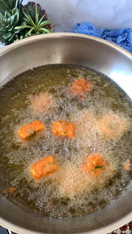Step 2.1: Drop each coated paneer cube and gently drop them into the hot oil, ensuring they are spaced apart to prevent sticking