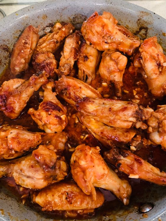 Step 3.1: Pour the prepared sauce over the wings, stirring to coat them evenly
