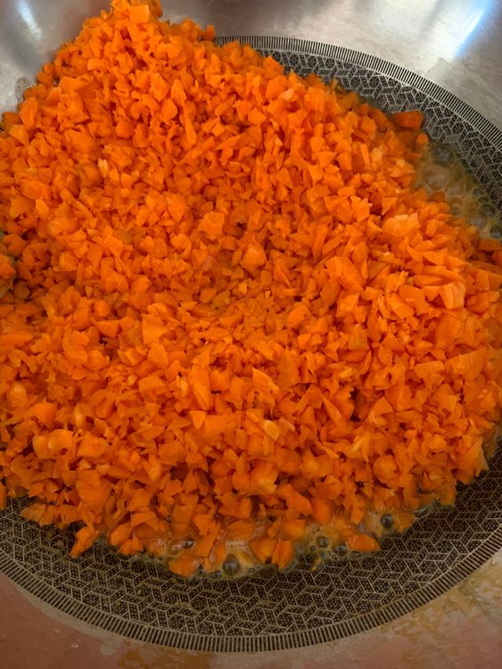 Step 1.1: Add the grated carrots and sauté over medium-high heat for 2-3 minutes until they soften slightly