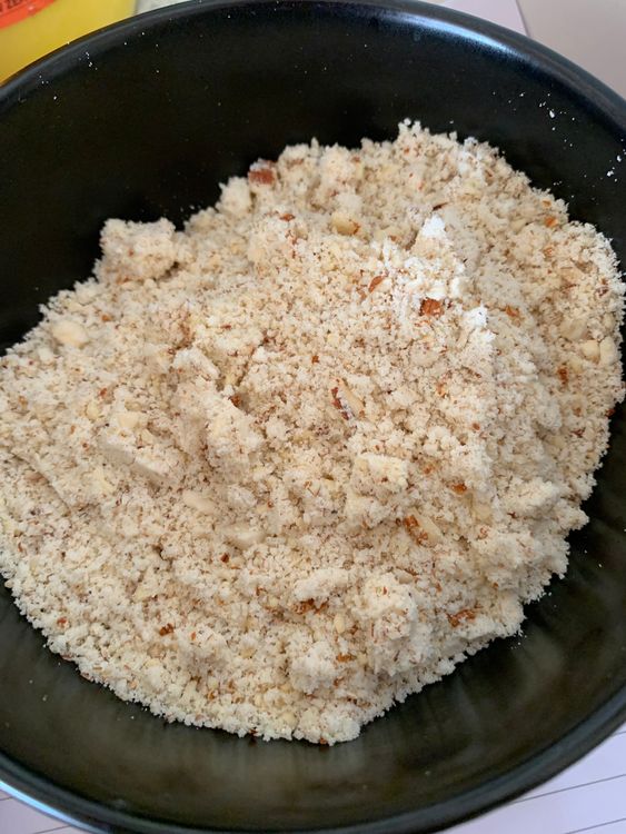 Step 1.1: In a blender, grind the mixed nuts, milk powder, 1 cup desiccated coconut, and cardamom powder into a fine blend