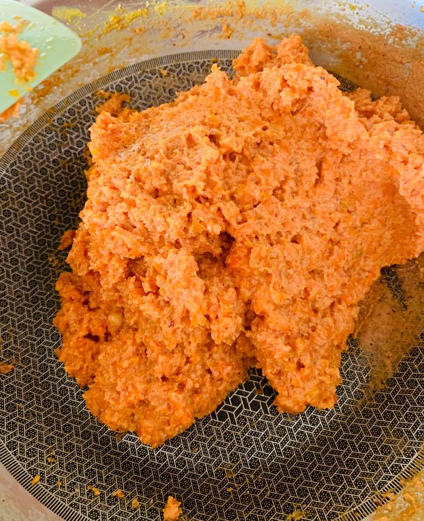 Step 1.2: Stir in the ground nut-coconut blend and continue cooking until the mixture thickens and comes together like soft dough