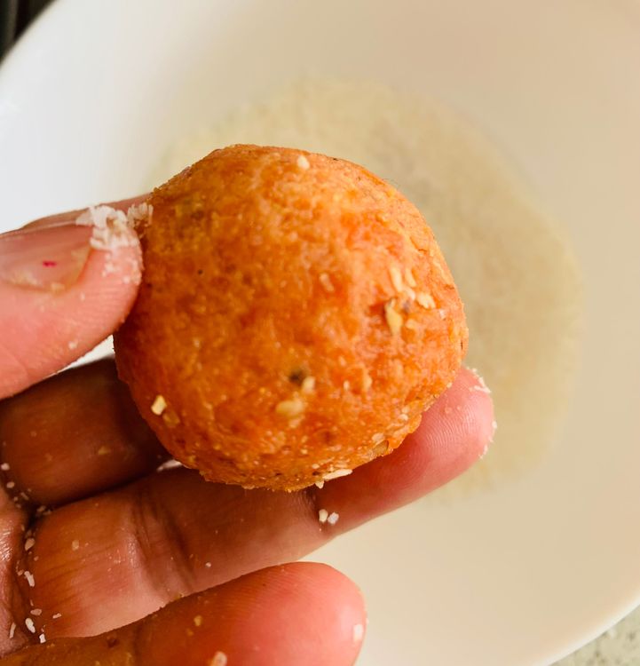 Step 1.1: Lightly grease your hands with ghee or oil and shape the mixture into small round ladoos