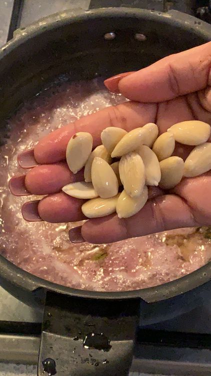 Step 1.2: Soak the almonds in hot water for 30 minutes, then peel off the skin, make a paste using a blender, and set the almond paste aside