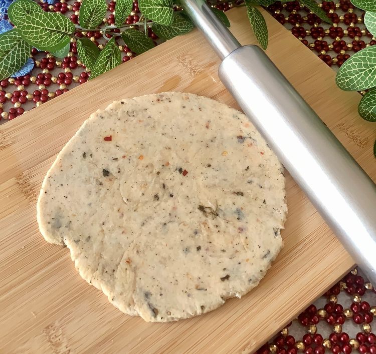 Step 1.1: Brush some oil on a rolling board, place a ball of dough, and roll it into a round disc of approximately 9 inches, making it slightly thick