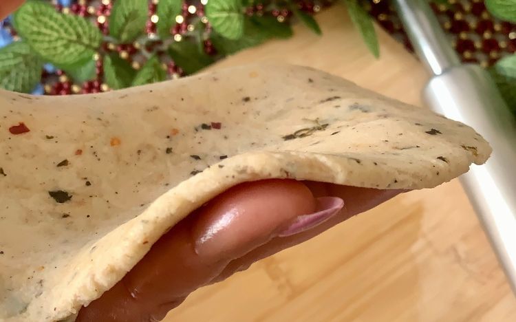 Step 1.2: Brush some oil on a rolling board, place a ball of dough, and roll it into a round disc of approximately 9 inches, making it slightly thick