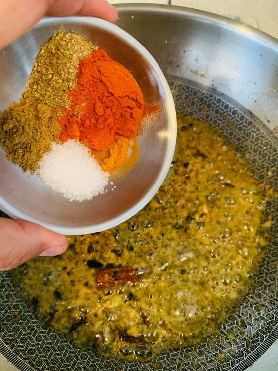 Step 3.1: Reduce the heat and add turmeric powder, Kashmiri chilli powder, coriander powder, cumin powder, and salt