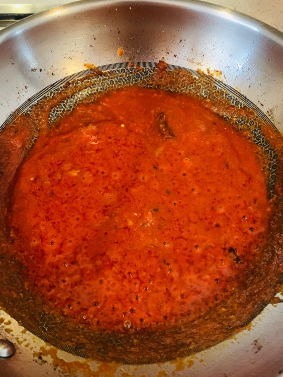 Step 3.1: Stir in the ground tomato and cook, stirring continuously, until the water content of the tomatoes evaporates