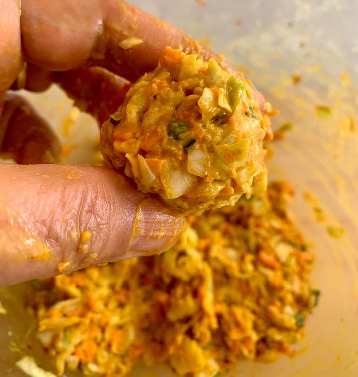 Step 1.1: Shape the mixture into small balls and carefully drop them into the hot oil