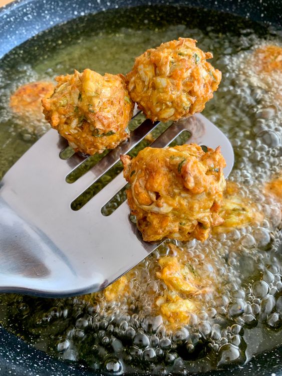 Step 1.2: Shape the mixture into small balls and carefully drop them into the hot oil