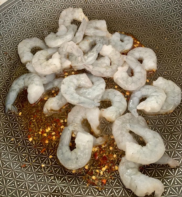 Step 1.1: Add red chilli flakes, black pepper powder, salt, and the prawns to the hot skillet