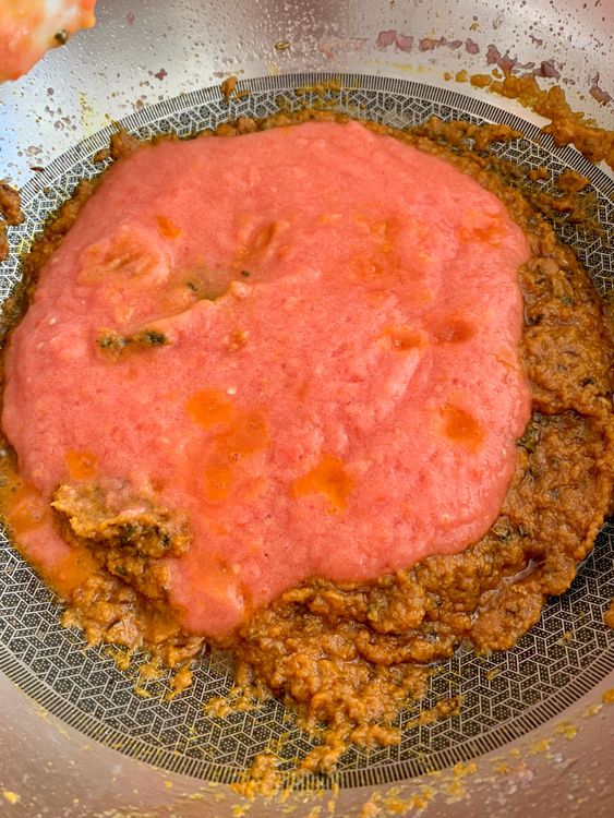Step 2.1: Add ground tomatoes and curd while stirring continuously