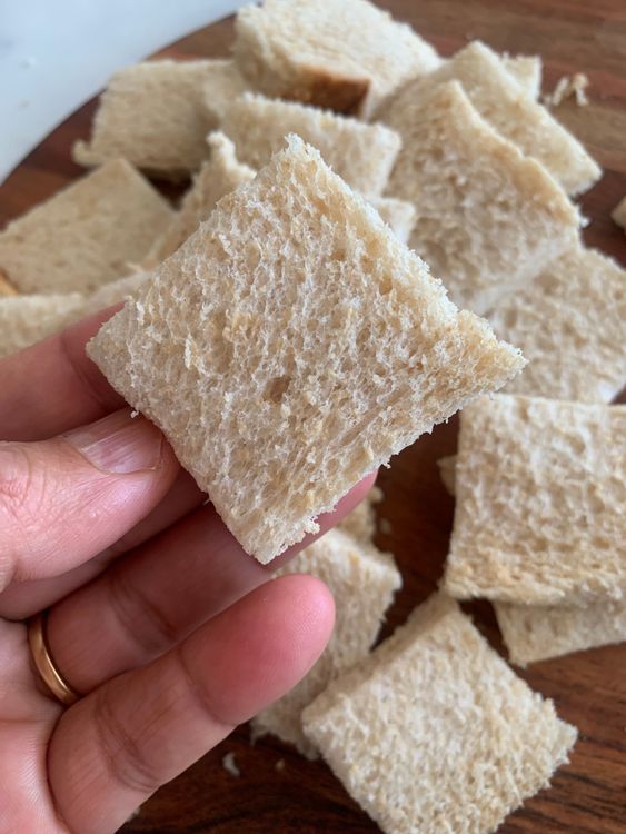 Step 1.1: Trim the edges of the bread slices and cut each slice into 4 small squares