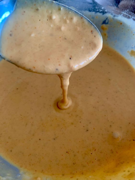 Step 2.1: Gradually add water while whisking until you get a smooth, flowing batter that coats the bread evenly