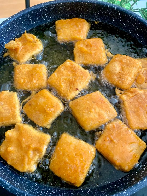 Step 3.1: Dip each bread piece into the batter, ensuring an even coat, and carefully place them in the hot oil in batches