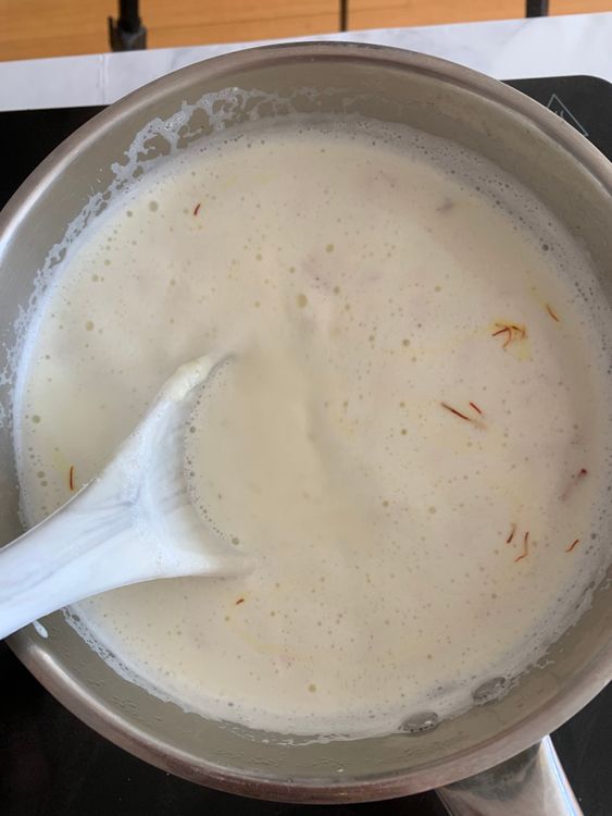Step 2.1: Add saffron strands and stir until the milk thickens slightly to a creamy consistency